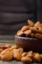 peeled-almonds-clay-plate-stone-tile-wooden-background (1).webp