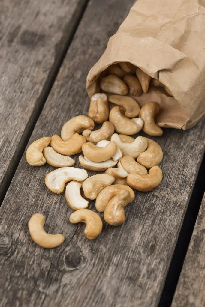 overturned-paper-bag-filled-with-healthy-raw-cashew-nuts.webp